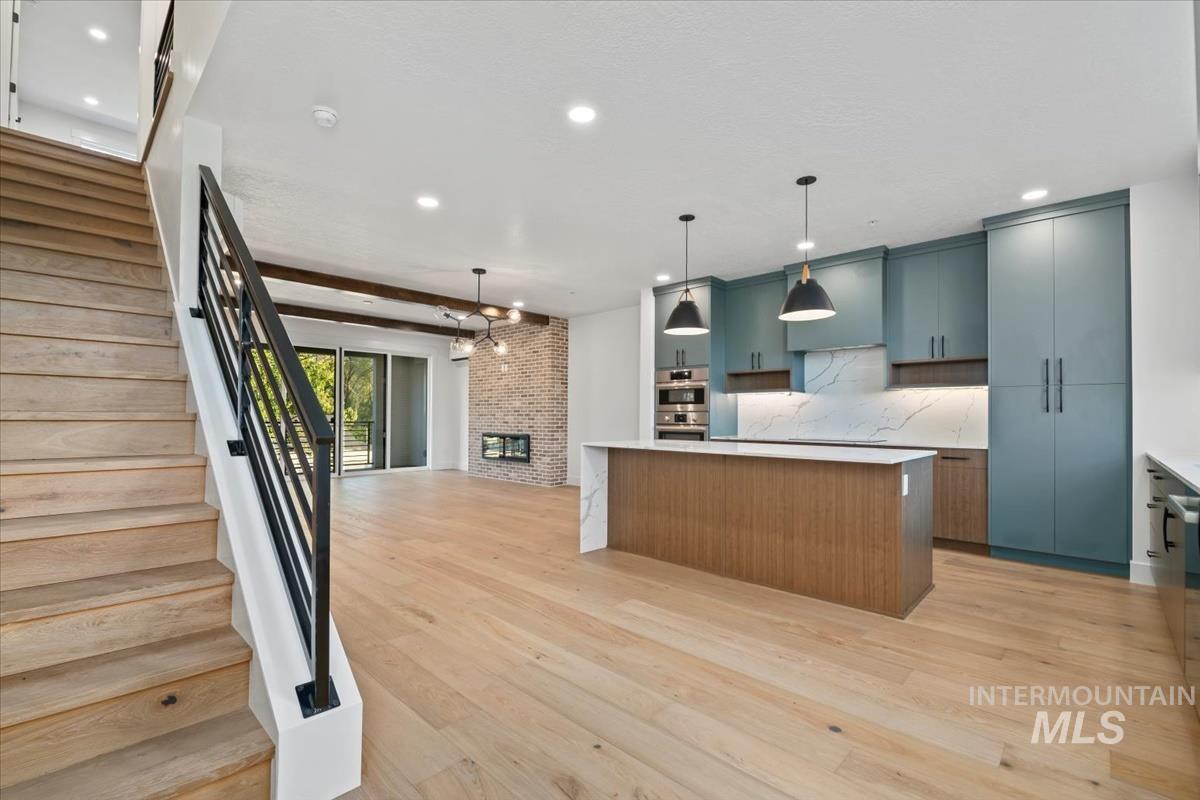 3249 West Moore Street Boise, ID 83702 - Photo 34 of 35 Kitchen featuring a center island, open floor plan, modern cabinets, light wood finished floors, and recessed lighting