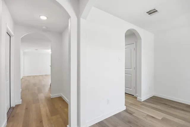 wooden floor in an empty room with a window