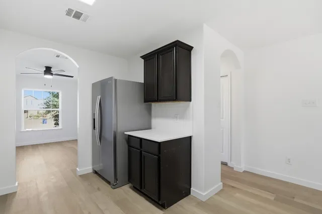 a kitchen with stainless steel appliances wooden cabinets a stove and a sink