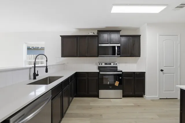 a kitchen with a refrigerator and a sink