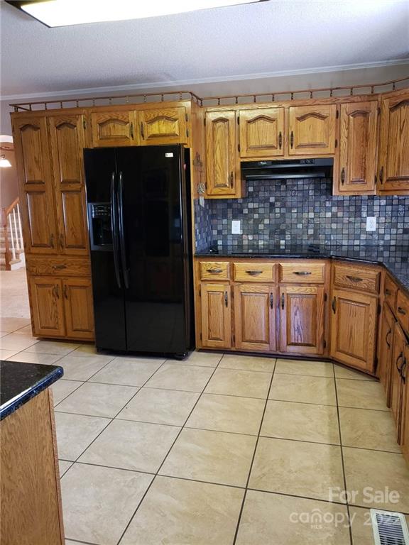 5418 East Lawyers Road Wingate, NC 28174 - Photo 14 of 40 a kitchen with stainless steel appliances granite countertop a refrigerator and a stove