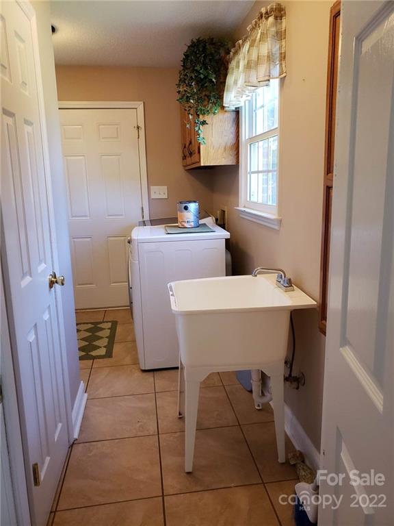 5418 East Lawyers Road Wingate, NC 28174 - Photo 29 of 40 a bathroom with a sink toilet and mirror