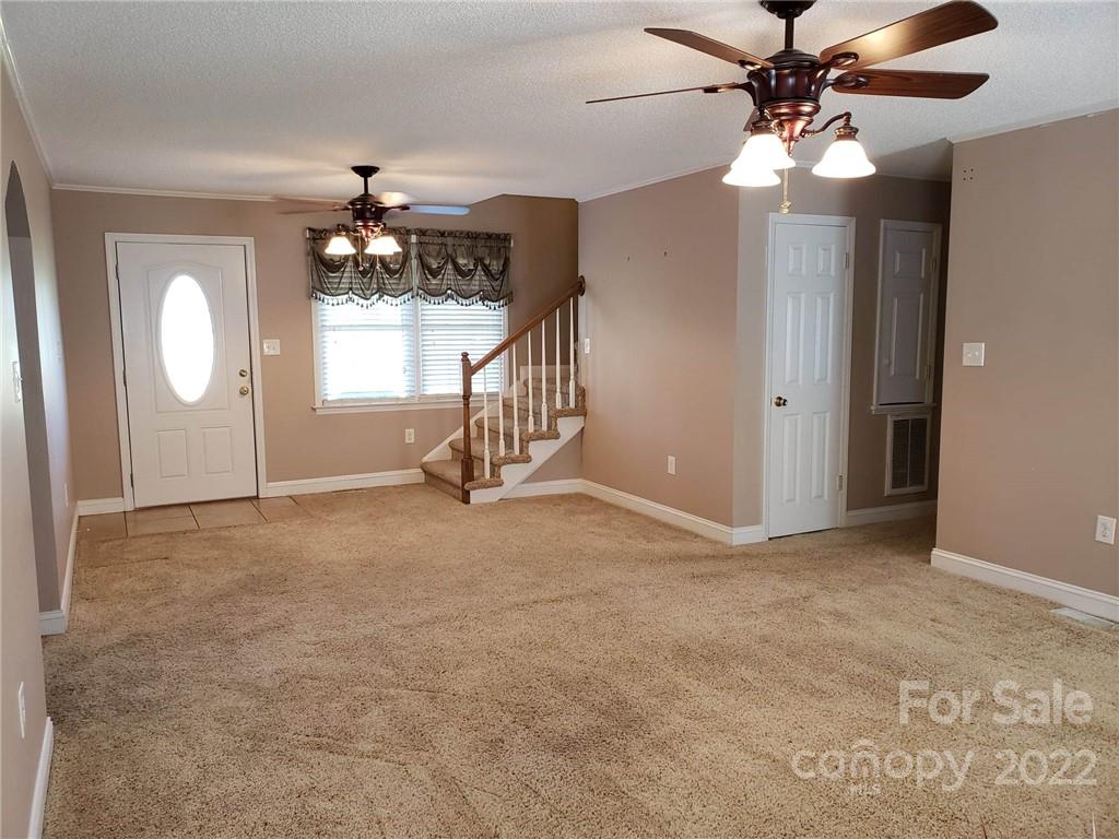 5418 East Lawyers Road Wingate, NC 28174 - Photo 8 of 40 an empty room with windows and fan