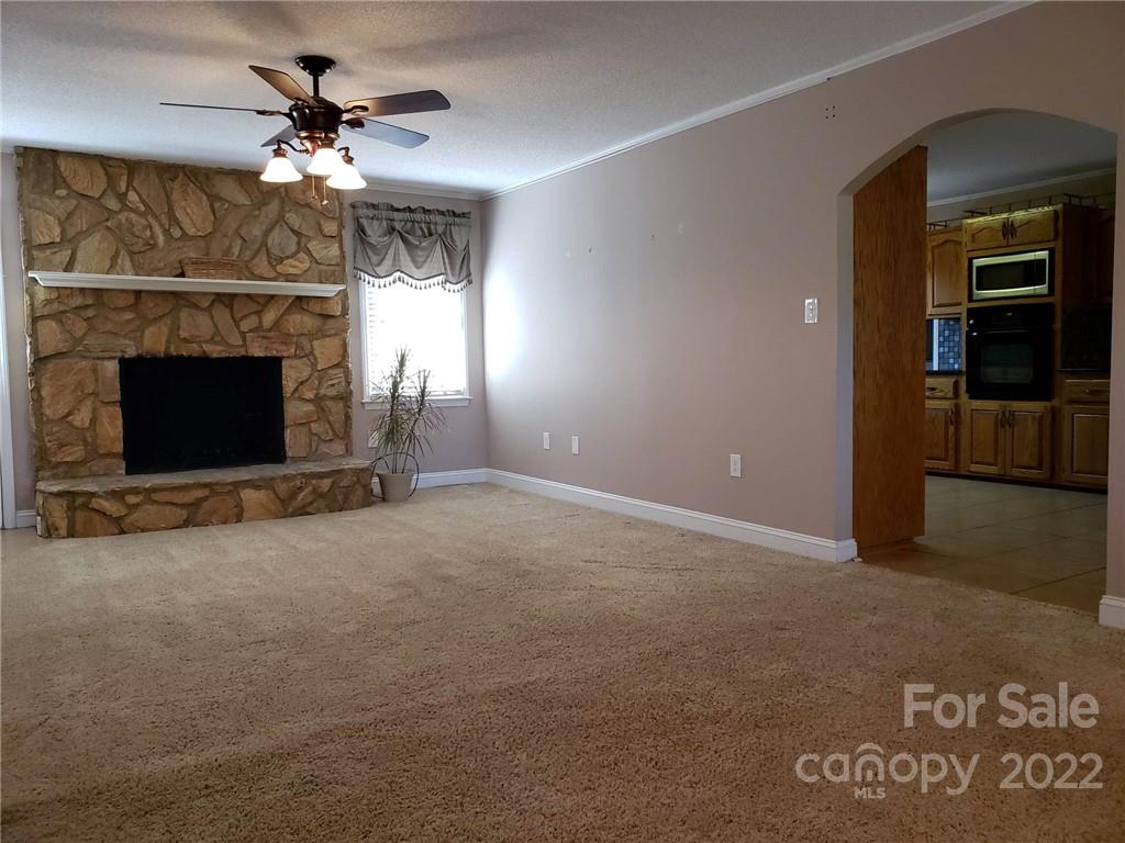 5418 East Lawyers Road Wingate, NC 28174 - Photo 9 of 40 a view of a livingroom with a fireplace and window