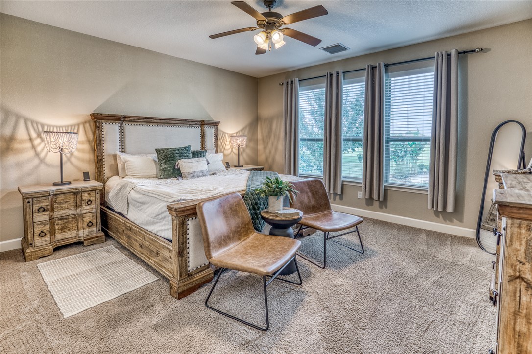 586 Ruby Drive Bellville, TX 77418 - Photo 17 of 50 a bedroom with a bed chair and a large window