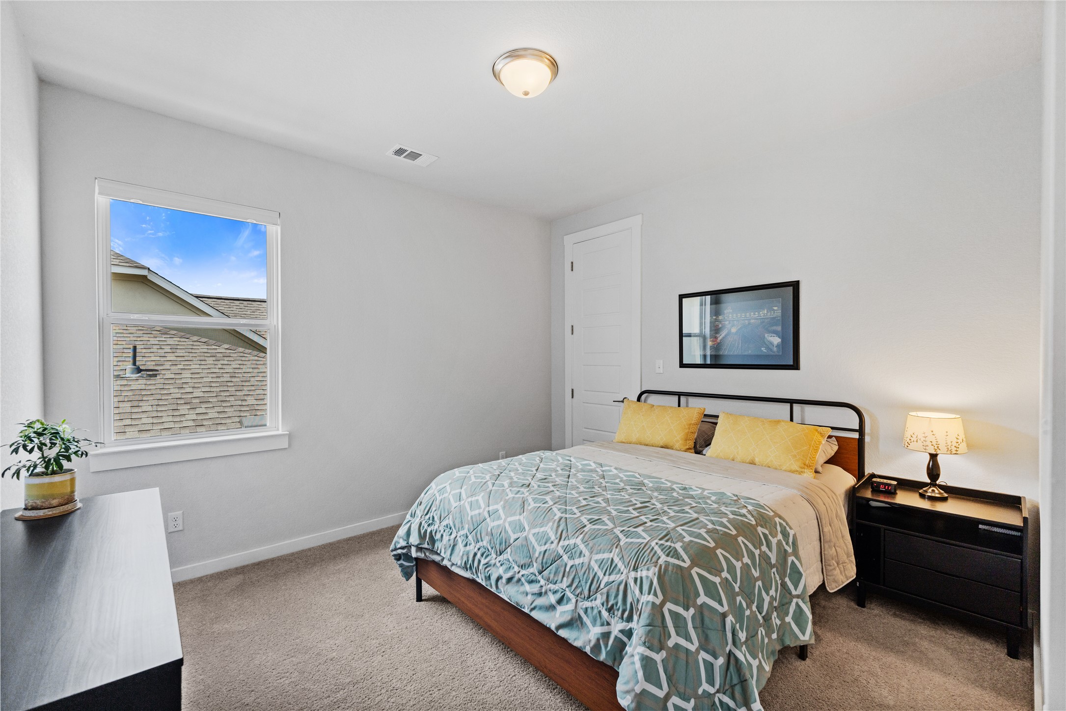 1209 Willie Rnch Way Leander, TX 78641 - Photo 29 of 37 a bedroom with a bed and a lamp on dresser
