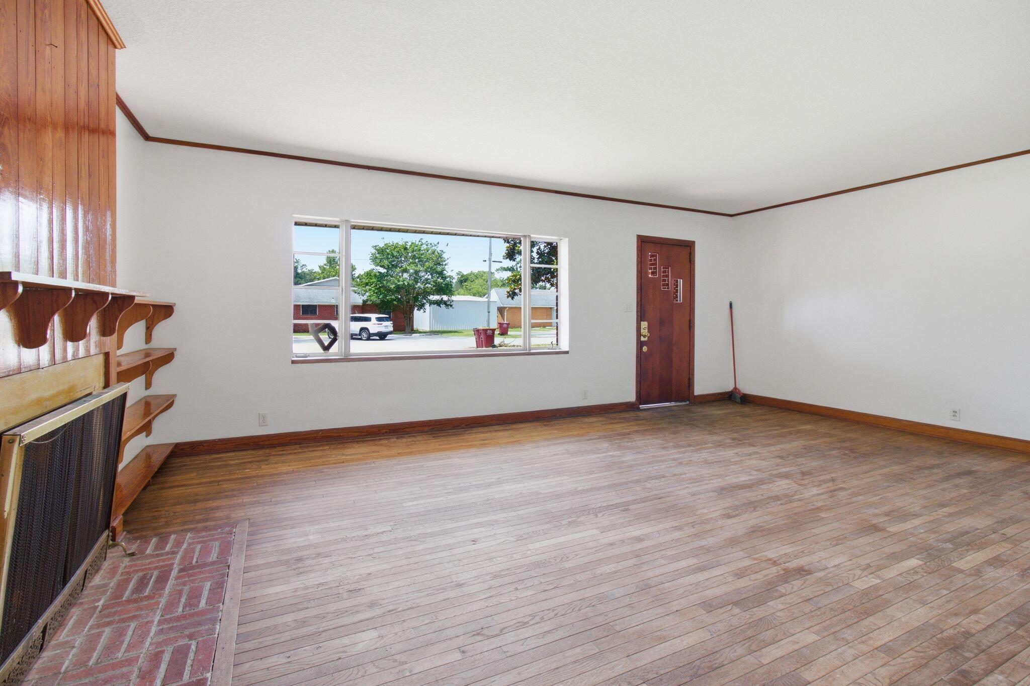 855 North Pearl Street Crestview, FL 32536 - Photo 20 of 31 a view of a room with window and wooden floor