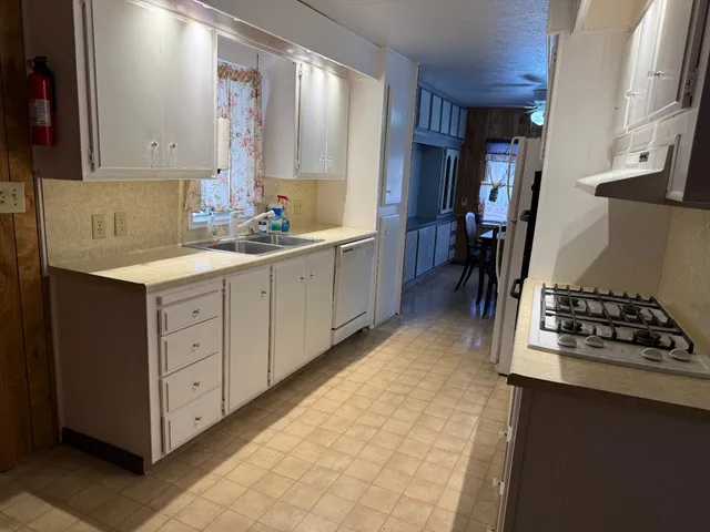 a kitchen with stainless steel appliances a sink stove and cabinets