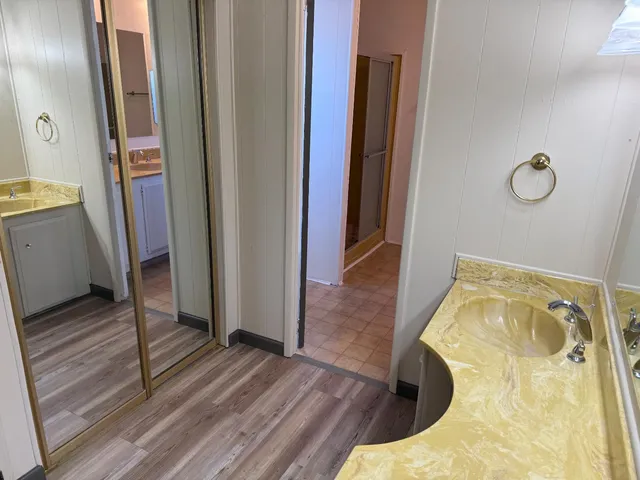 a bedroom with a bed and a mirror