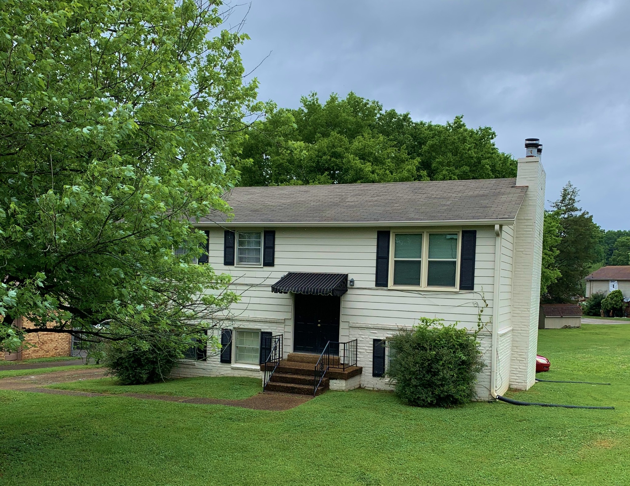 3060 Anderson Road Nashville, TN 37217 - Photo 1 of 43 a front view of a house with a garden
