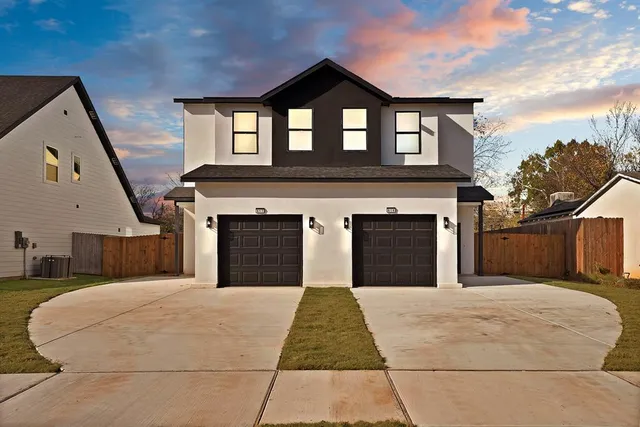 a view of a brick house with a small yard