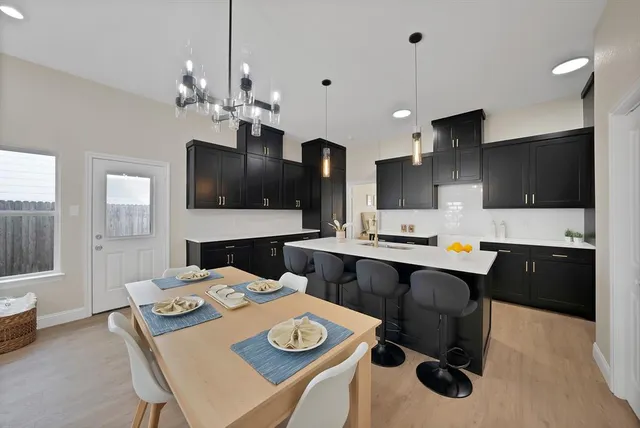 a kitchen that has a table and a stove in it