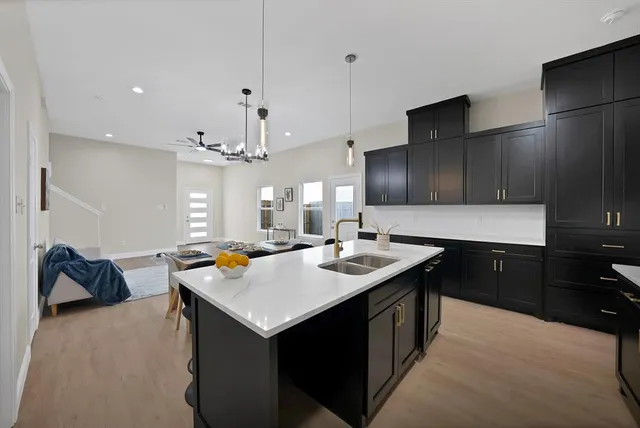 a kitchen with a sink stove and cabinets