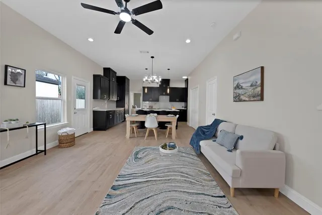 a living room with furniture and kitchen view