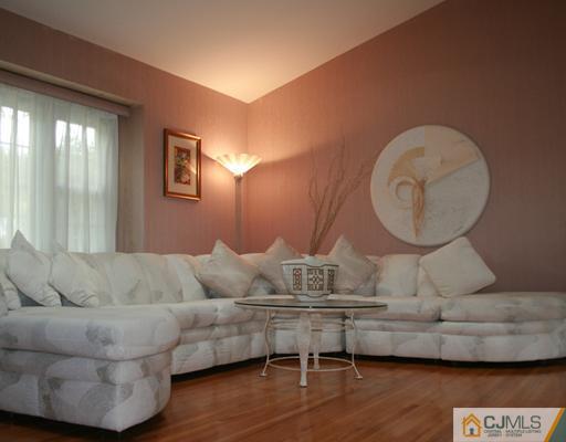 69 Dellwood Road Edison, NJ 08820 - Photo 2 of 9 a living room with furniture and a large mirror