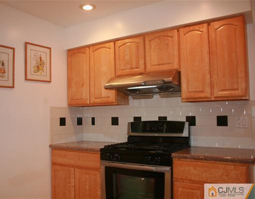 69 Dellwood Road Edison, NJ 08820 - Photo 3 of 9 a kitchen with stainless steel appliances granite countertop a stove a sink and a microwave