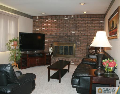 69 Dellwood Road Edison, NJ 08820 - Photo 5 of 9 a living room with furniture and a flat screen tv