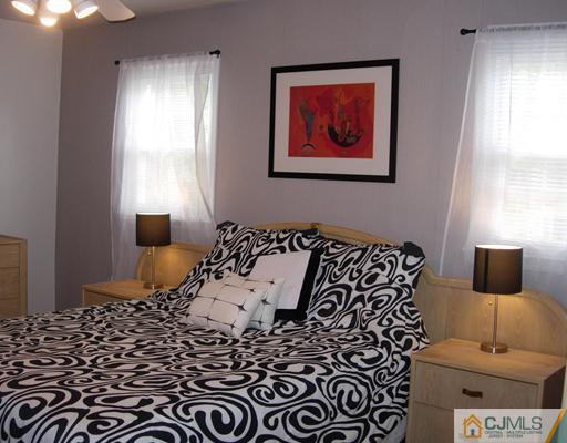 69 Dellwood Road Edison, NJ 08820 - Photo 7 of 9 a bed room with a bed and a window