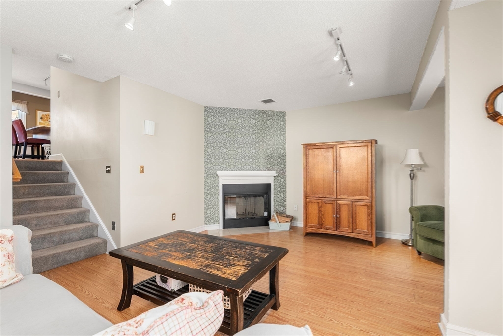 1 Spruance Way, Unit D Salem, MA 01970 - Photo 11 of 22 a view of a livingroom with furniture and fireplace