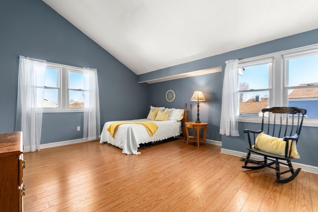 1 Spruance Way, Unit D Salem, MA 01970 - Photo 12 of 22 a bedroom with a bed and wooden floor
