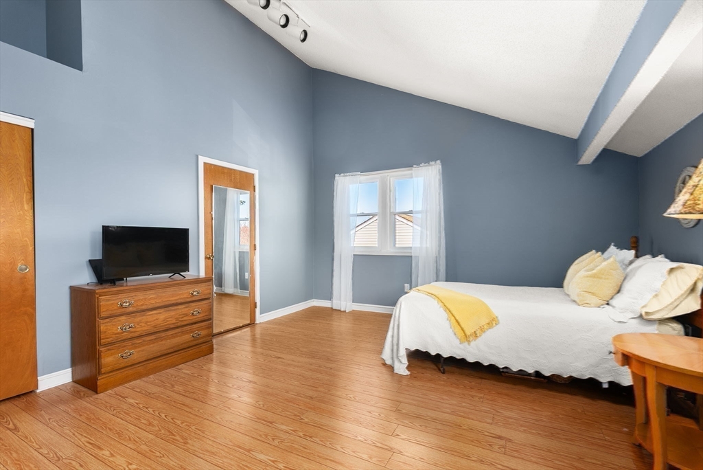 1 Spruance Way, Unit D Salem, MA 01970 - Photo 14 of 22 a bedroom with furniture and a flat screen tv