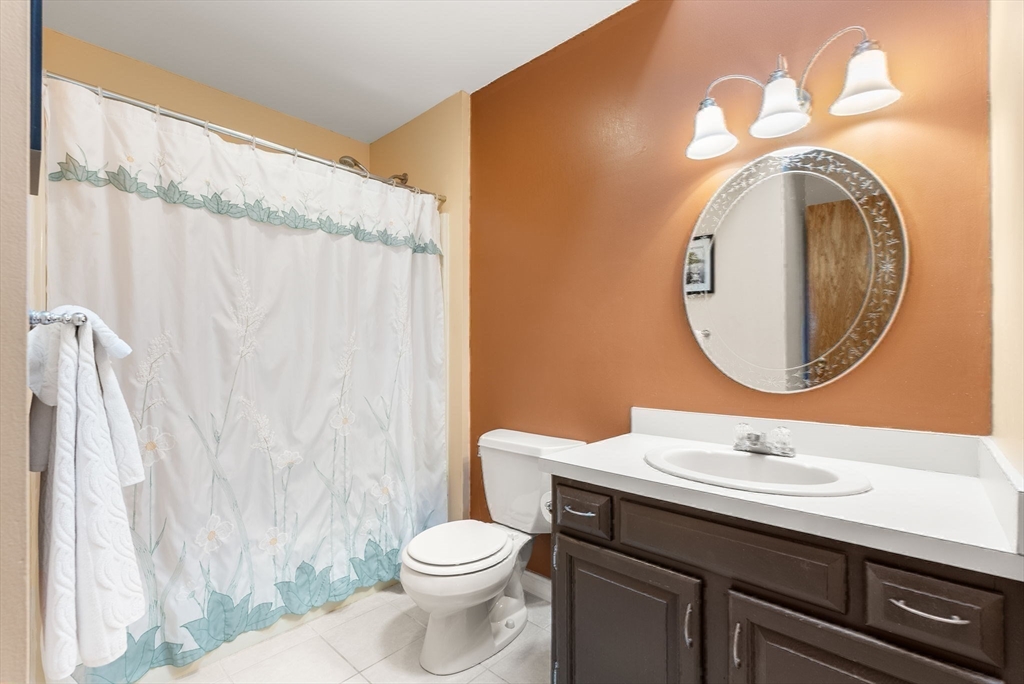1 Spruance Way, Unit D Salem, MA 01970 - Photo 15 of 22 a bathroom with a toilet a sink and a mirror