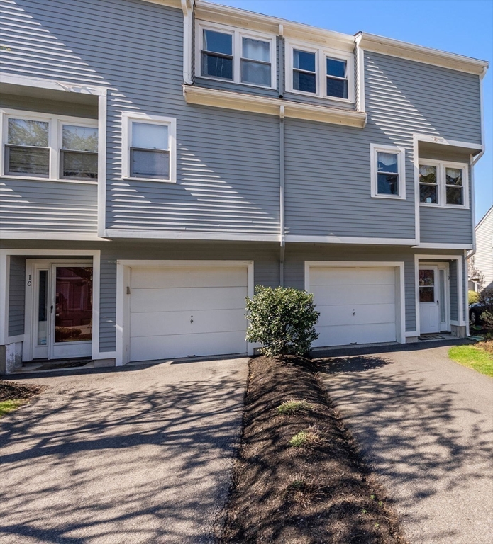 1 Spruance Way, Unit D Salem, MA 01970 - Photo 2 of 22 a front view of a house with a garden