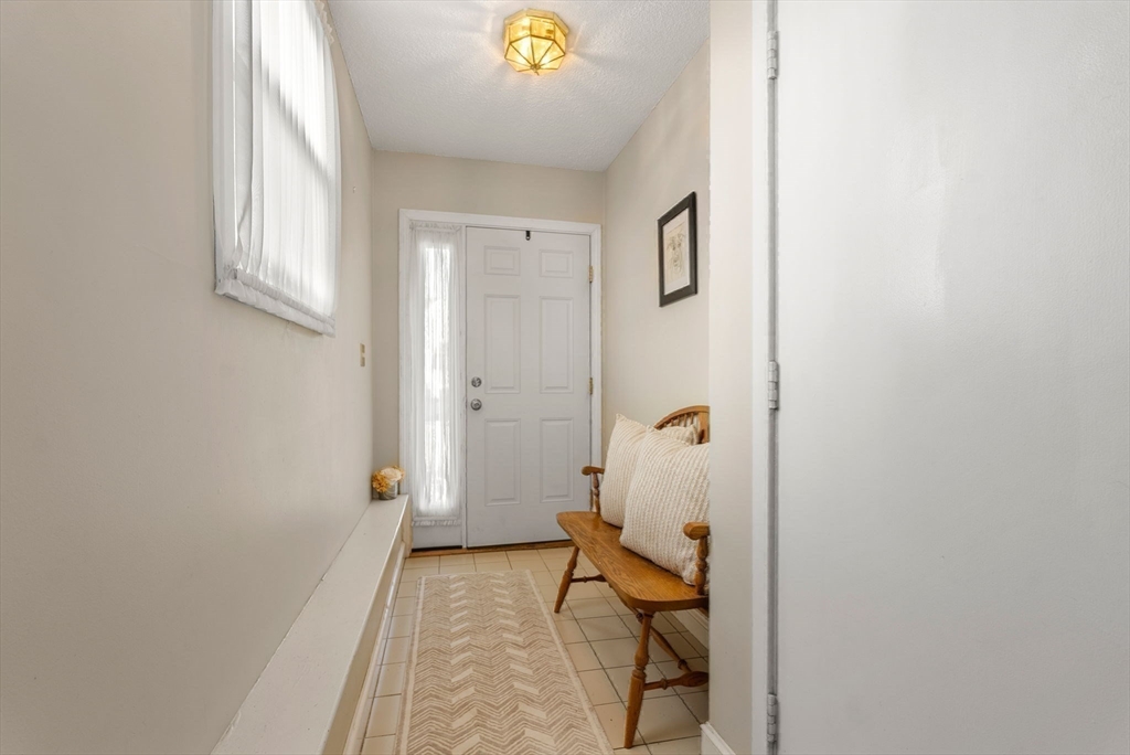 1 Spruance Way, Unit D Salem, MA 01970 - Photo 3 of 22 a view of a hallway with wooden floor and a bathroom