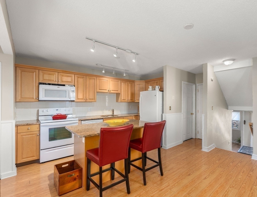 1 Spruance Way, Unit D Salem, MA 01970 - Photo 4 of 22 a kitchen that has a table and chairs in it
