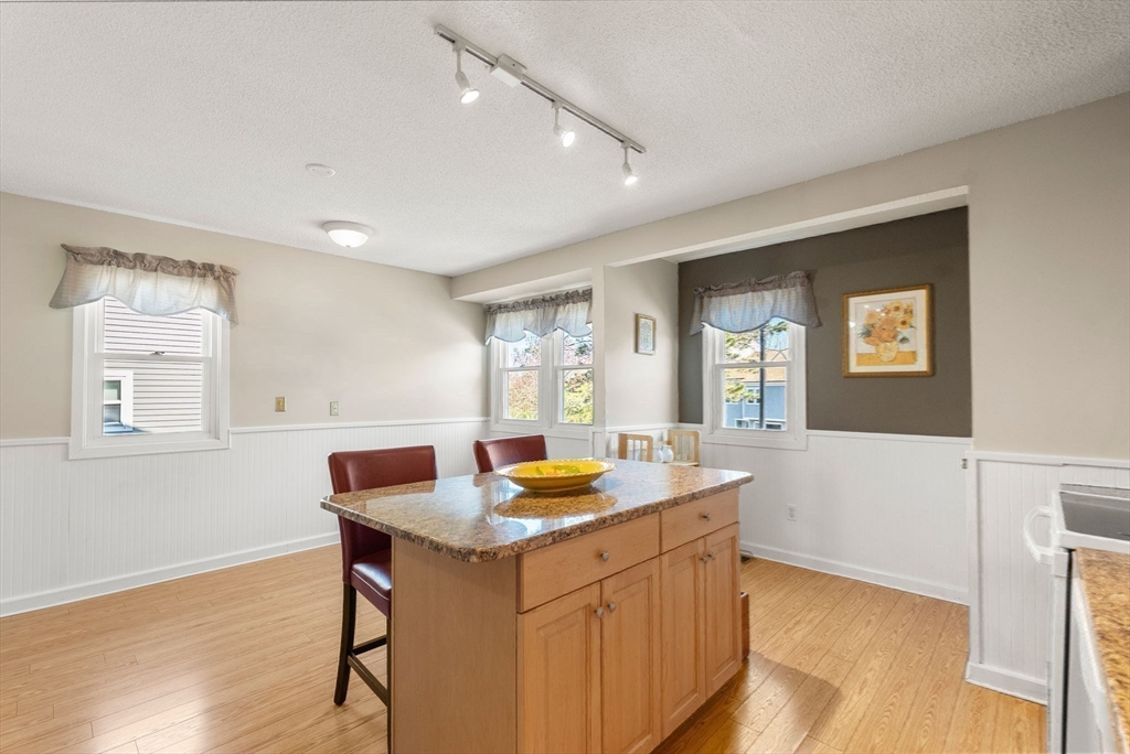 1 Spruance Way, Unit D Salem, MA 01970 - Photo 5 of 22 a kitchen with granite countertop a sink cabinets and wooden floor