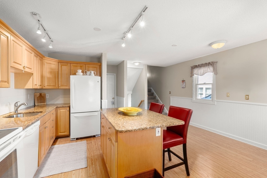 1 Spruance Way, Unit D Salem, MA 01970 - Photo 6 of 22 a kitchen with refrigerator and wooden floor