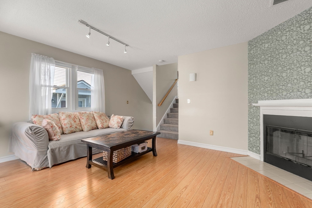 1 Spruance Way, Unit D Salem, MA 01970 - Photo 9 of 22 a living room with furniture and a fireplace