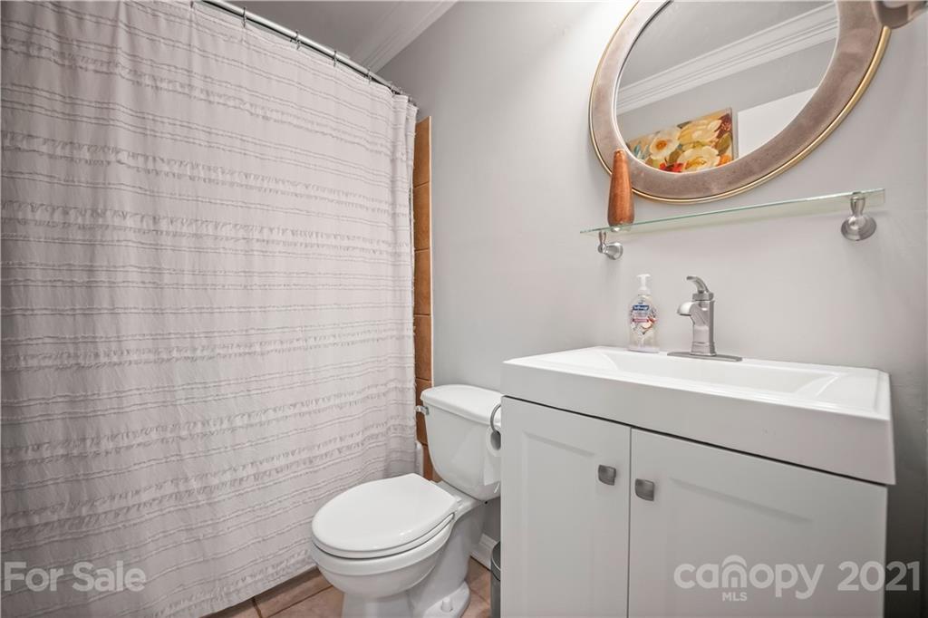 3854 Litchfield Road Charlotte, NC 28211 - Photo 14 of 35 a bathroom with a sink a mirror and a toilet