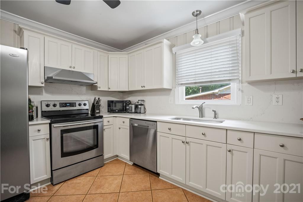 3854 Litchfield Road Charlotte, NC 28211 - Photo 8 of 35 a kitchen with white cabinets stainless steel appliances and sink