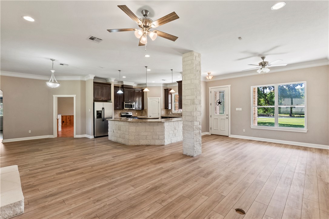 6701 Old Reliance Road Bryan, TX 77808 - Photo 6 of 44 an open kitchen with kitchen island and stainless steel appliances