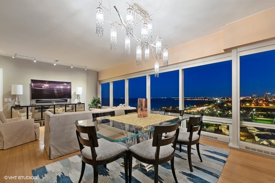 340 East Randolph Street, Unit 905 Chicago, IL 60601 - Photo 11 of 31 a view of a dining room with furniture a chandelier and wooden floor