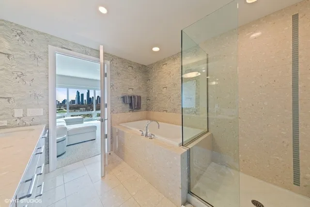 a spacious bathroom with a bathtub shower and sink