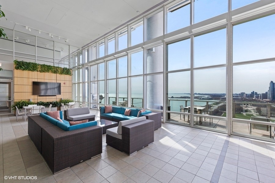 340 East Randolph Street, Unit 905 Chicago, IL 60601 - Photo 18 of 31 a living room with furniture city view and large windows