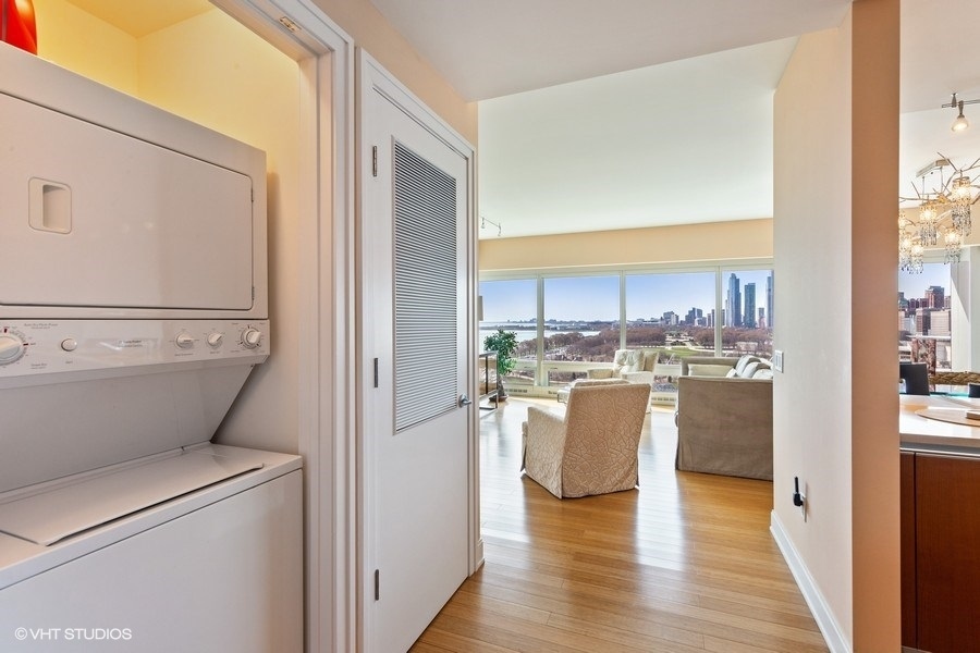 340 East Randolph Street, Unit 905 Chicago, IL 60601 - Photo 19 of 31 a view of a kitchen with wooden floor and electronic appliances