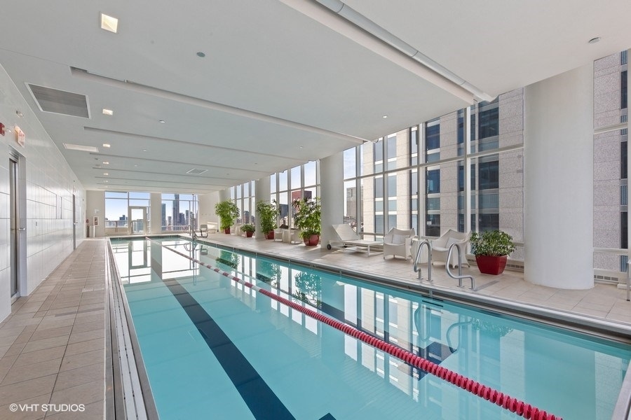 340 East Randolph Street, Unit 905 Chicago, IL 60601 - Photo 21 of 31 a living room with lots of furniture and a large window