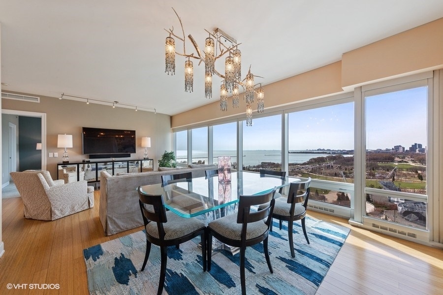 340 East Randolph Street, Unit 905 Chicago, IL 60601 - Photo 8 of 31 a view of a dining room with furniture window and wooden floor