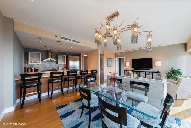 a living room with lots of furniture and kitchen view
