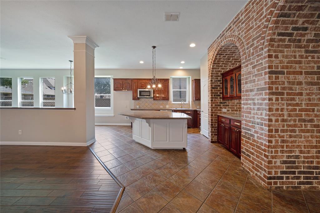 3418 Oakleigh Lane Frisco, TX 75033 - Photo 12 of 37 a large kitchen with stainless steel appliances and cabinets