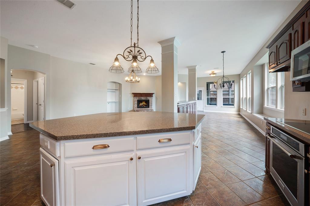 3418 Oakleigh Lane Frisco, TX 75033 - Photo 13 of 37 a spacious kitchen with stainless steel appliances granite countertop a stove and a sink