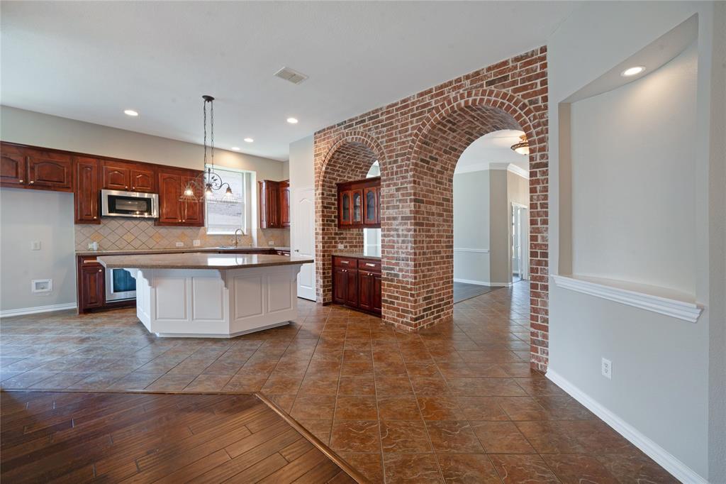 3418 Oakleigh Lane Frisco, TX 75033 - Photo 19 of 37 a large kitchen with stainless steel appliances granite countertop a large stove a sink and a microwave