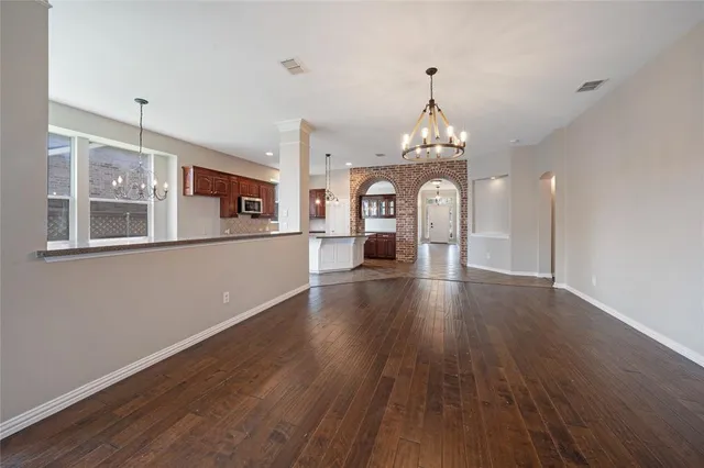 a large kitchen with kitchen island white cabinets and stainless steel appliances