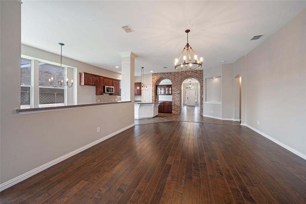 3418 Oakleigh Lane Frisco, TX 75033 - Photo 20 of 37 a view of a room with wooden floor a ceiling fan and windows