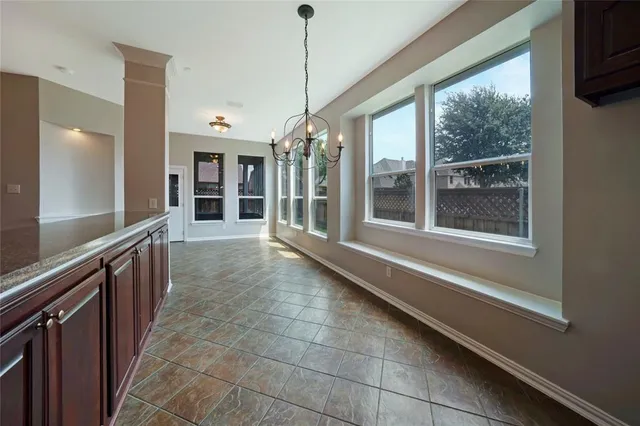 an empty room with wooden floor and a ceiling fan