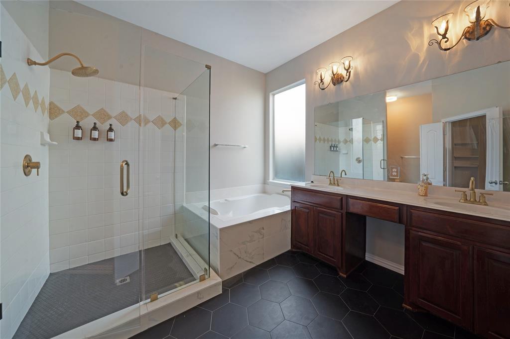 3418 Oakleigh Lane Frisco, TX 75033 - Photo 28 of 37 a bathroom with a double vanity sink a toilet a mirror and shower