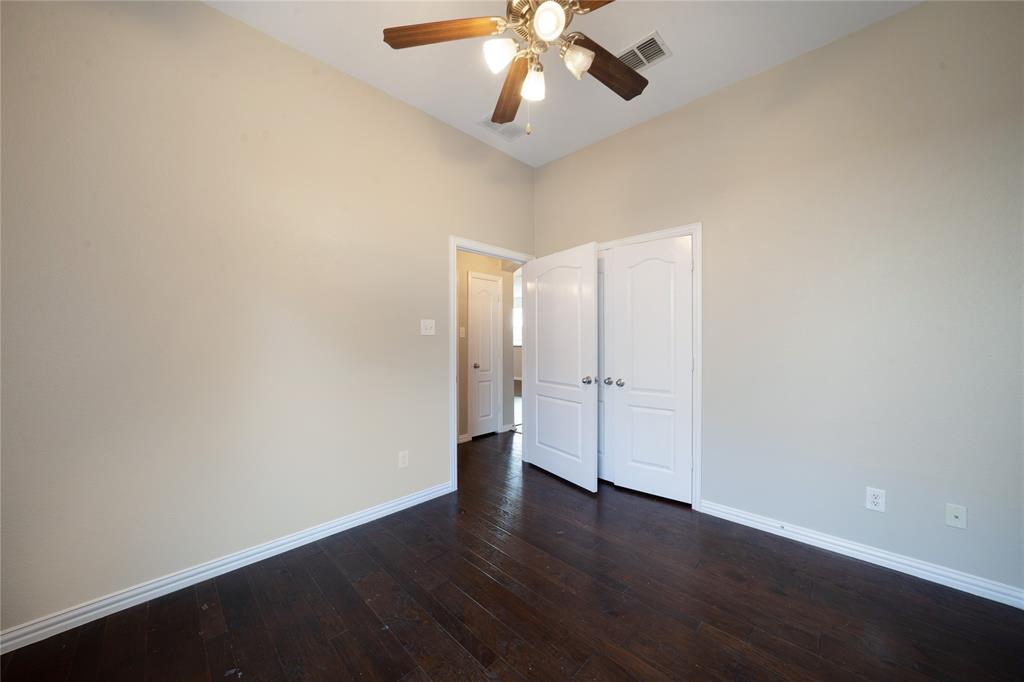 3418 Oakleigh Lane Frisco, TX 75033 - Photo 32 of 37 a view of an empty room with wooden floor and a ceiling fan